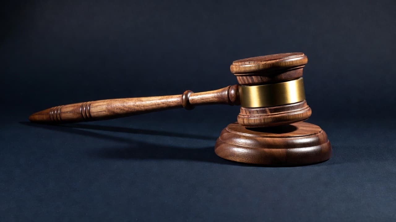 Wooden gavel resting on a dark surface